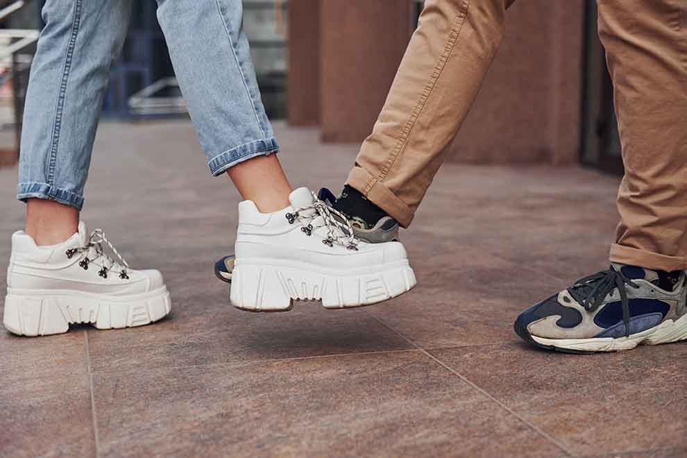 Casal usando tênis estilosos em ambiente urbano